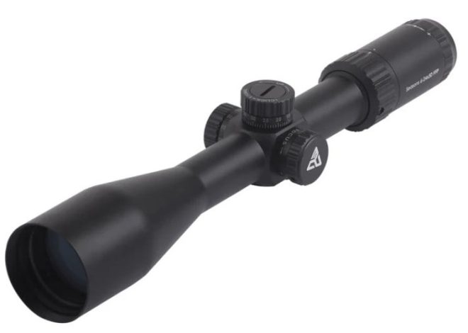 Black rifle scope with adjustment knobs and eyepiece, shown in close-up.