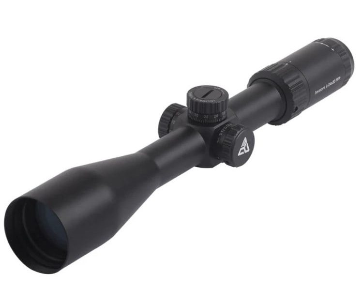 Black rifle scope with adjustment knobs and eyepiece, shown in close-up.