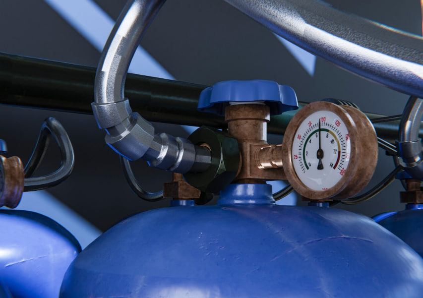 Close-up of blue gas cylinders with brass pressure regulator and round gauge connected to metal piping.