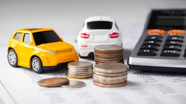 Two toy cars, a stack of coins, and a calculator arranged on financial documents, suggesting car budgeting or financing.
