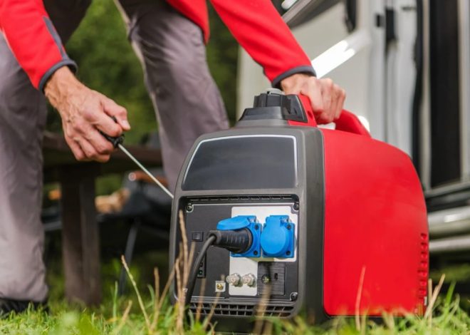 Person operating a red portable generator outdoors, connecting a cable to the blue outlet panel.