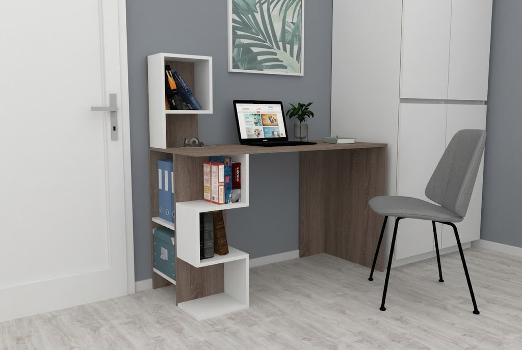 Home office desk with a laptop, chair, plant, and white shelving unit in a gray-walled room.