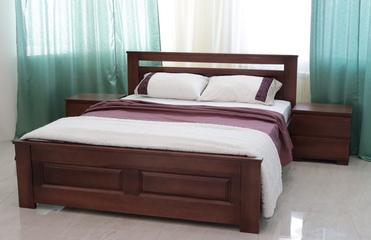Queen-size wooden bed with matching nightstands, burgundy bedding and white pillows in a bright room with teal curtains.