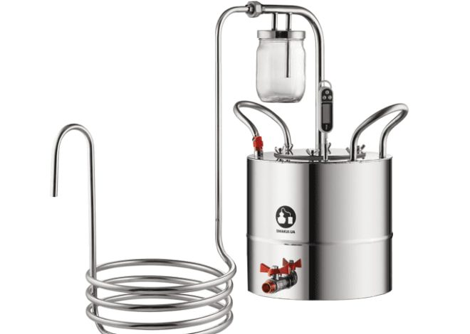Stainless steel distillation unit with coil condenser and a collection jar for distilling liquids.