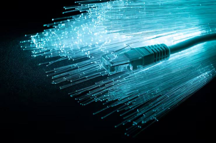 Blue fiber optic cable with glowing strands fanning out, illustrating high-speed networking.