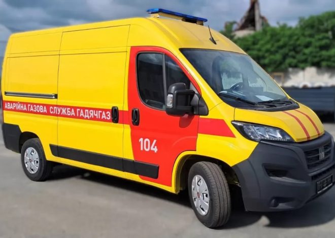 Yellow and red emergency van (ambulance) with '104' on the door and Cyrillic text along the side, ready for service.