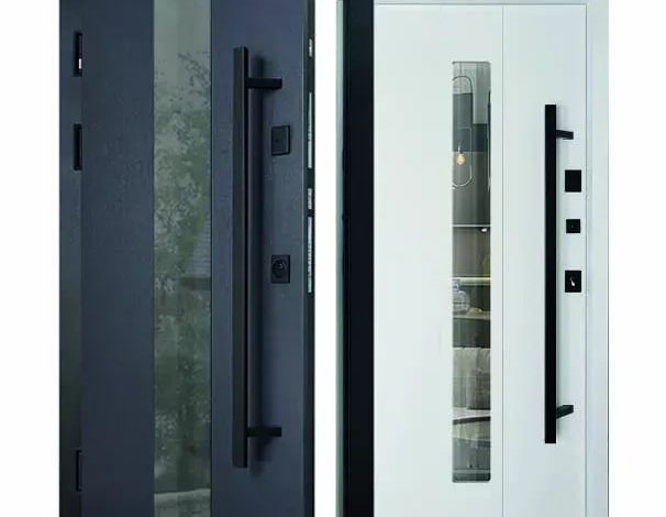 Double-entry door system: a dark exterior door open to reveal a white interior door with a tall vertical glass panel.