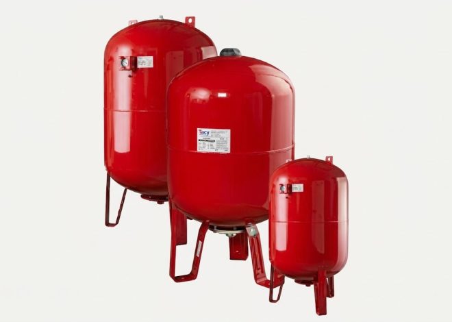 Three red vertical pressure tanks mounted on metal legs against a light background.