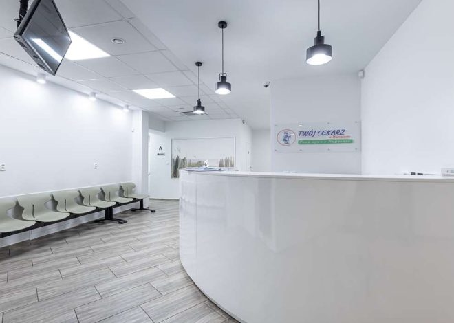 Modern medical clinic reception with a curved white front desk, pale green chairs along the wall, and a banner reading 'Twój Lekarz' in the background; bright, clean space.