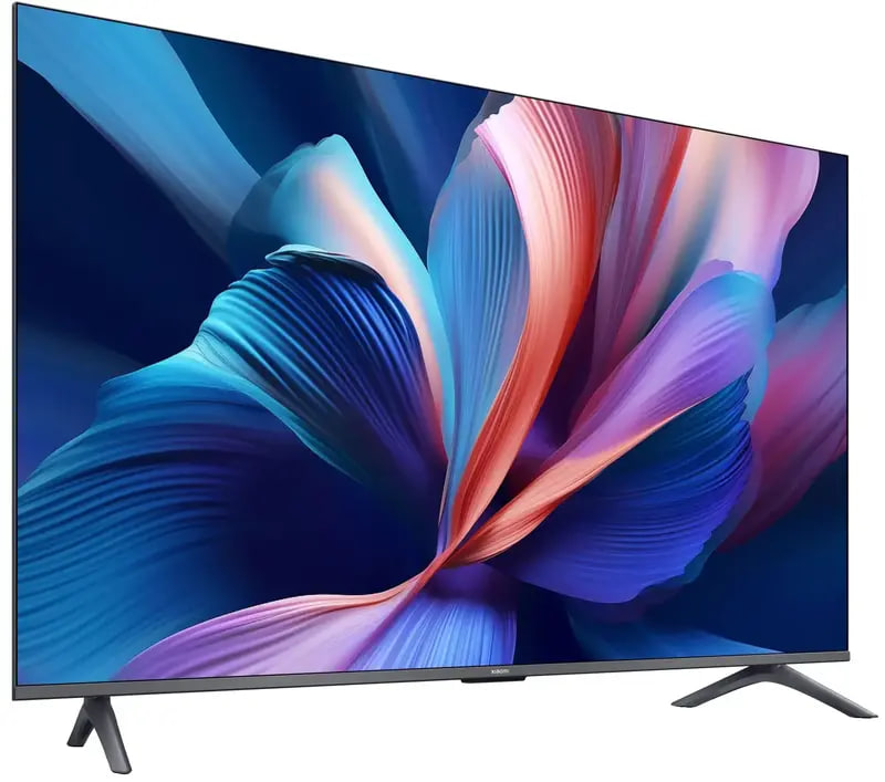 Flat-screen TV on a white background displaying a vibrant abstract wallpaper with blue and pink petals, thin bezel and angled stands.